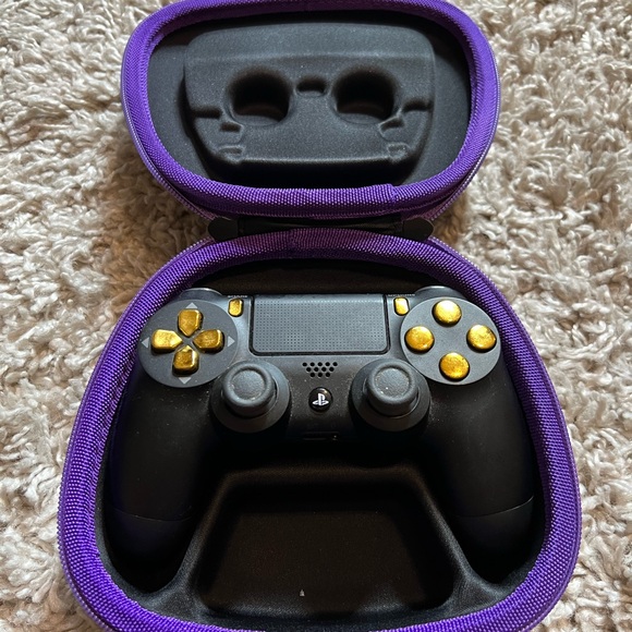 Sony dual shock modified PS4 controller, black and gold with hard case.